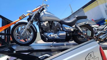 Towing a Honda 1300 to a customer.