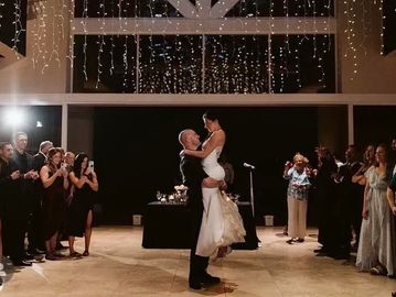 Couple dancing joyfully at their wedding reception.