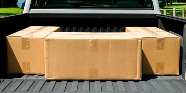 Cardboard boxes arranged in a U-shape in a truck bed.