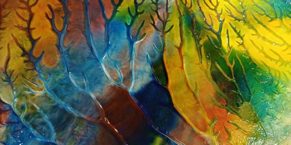 Colorful abstract painting with tree-like patterns.