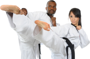 Two martial arts students doing a side kick