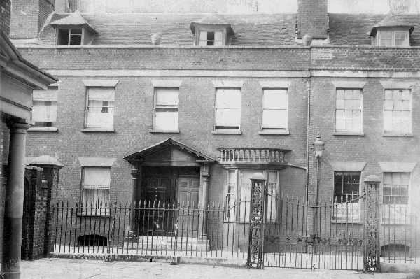 Georgian facade with doorways and windows behind tall railing