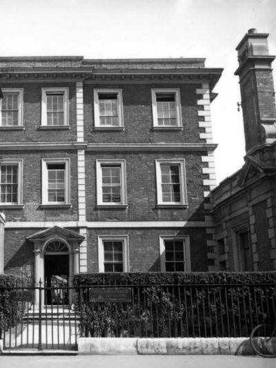 Tall terrace three-story house with grand doorway and white framed windows