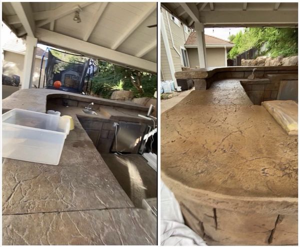 Outdoor kitchen with stone countertops and a covered patio area.