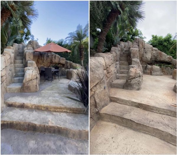 Outdoor stone steps and patio with umbrella and seating area.