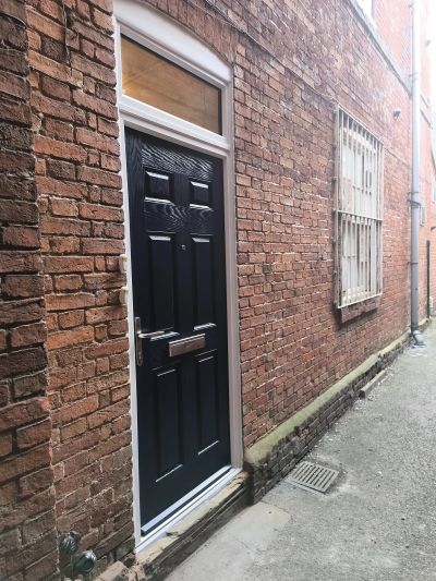 Black externally rated FD30 fire door with a topbox fitted in Newark.