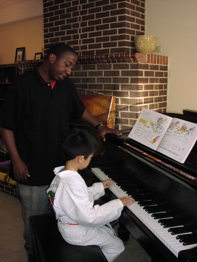 Piano teacher instructs student