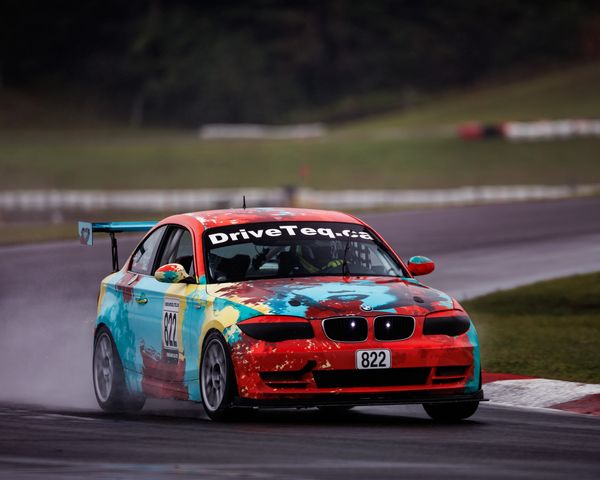 Colorful race car on wet track.