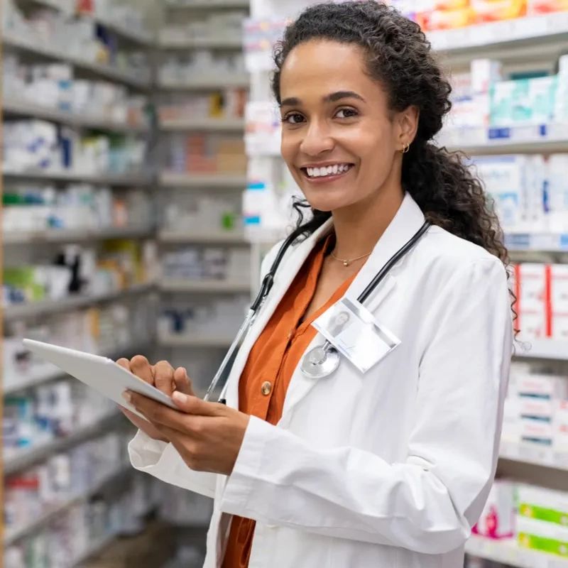 A pharmacist looking at the camera