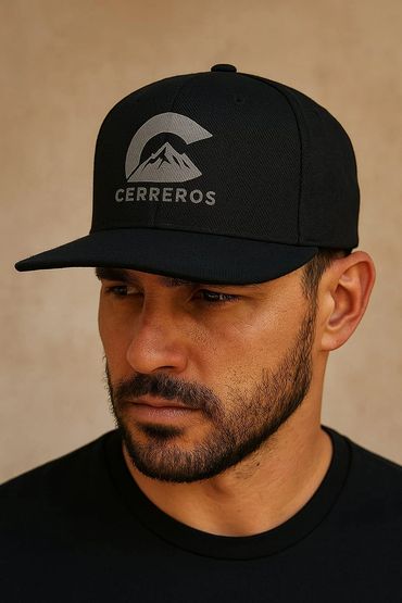 Man wearing a black cap with a mountain logo and the word 'CERREROS'.