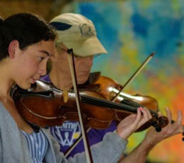 Joe Jewett and a violin student playing together