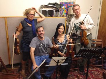 Joe Jewett performing with a string quartet - violins, viola, and cello