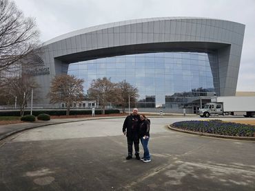 Couple standing outside the Center for Disease Control in The Walking Dead in Atlanta.