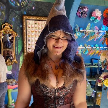 Woman in a fantasy-themed costume with a hood and fur collar.