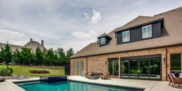 Luxury home for sale in Mckinney, Texas with a rectangle pool design and hot tub.