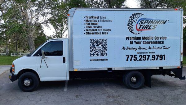 Mobile tire service truck offering sales, repairs, and tire swaps with contact info.