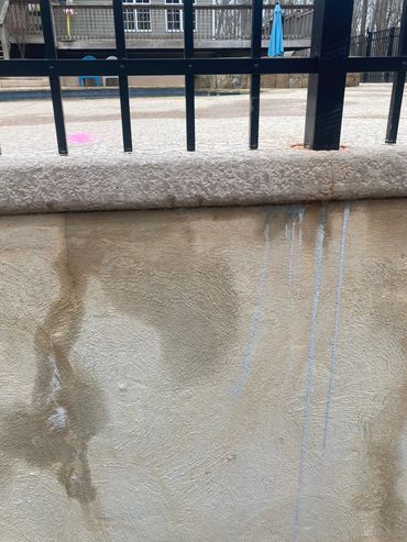 Water seepage from retaining wall due to unaddressed spa leak