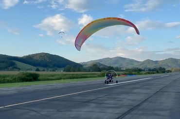 Our Powered paraglider instructor takes off in the mountains of Tennessee. Powered paragliding.