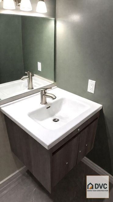 Bathroom renovation in Vancouver including vinyl flooring, toilet and vanity installation