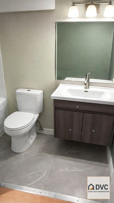 Bathroom renovation in Vancouver including vinyl flooring, toilet and vanity installation