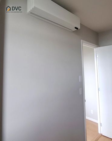 Finished wall beneath a wall-mounted unit after drywall repair
