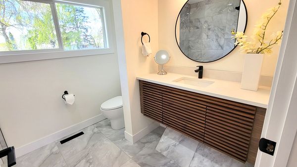 Full bathroom renovation. New floor and ceiling tile,  New cabinetry, new sink.