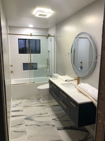 Bathroom remodel with light ring mirror