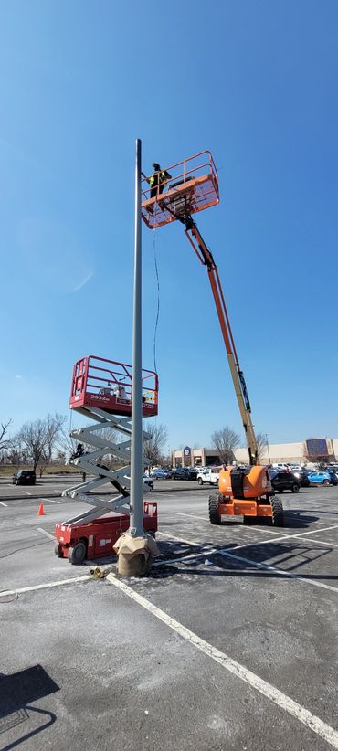 Electrostatic Painter in lift working 40 feet off the ground