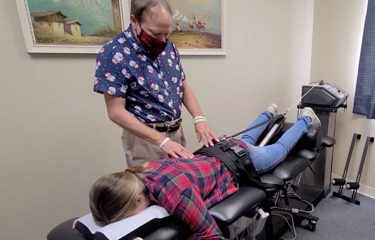 Dr. Albert Gadomski, D.C. treats a patient on a spinal decompression table