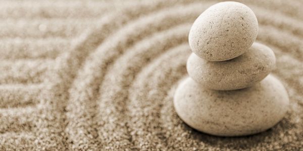 zen symbol - a mindfulness related image with 3 stones balancing one on the other