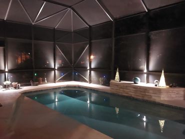 Pool cage sconces light up the patio area, and they are color-changing!