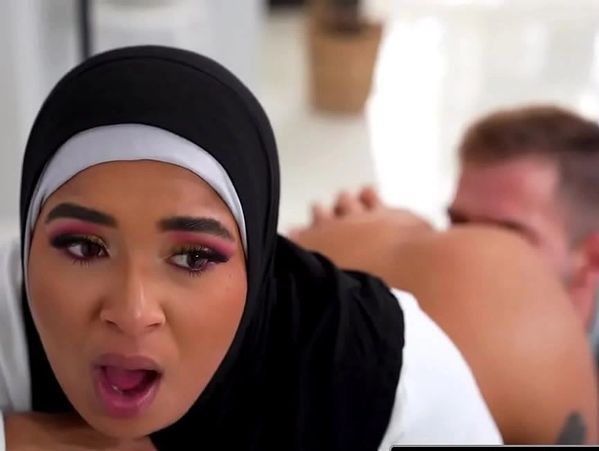 A woman in a hijab showing surprise or shock in a close-up shot.