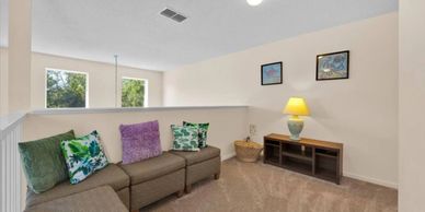 Cozy living space with sectional sofa and colorful pillows.