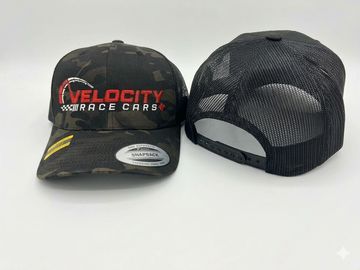 Two black baseball caps, one front-facing with 'Velocity Race Cars' logo, one back-facing.