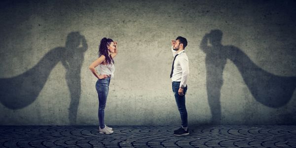 Side view of a man and woman imagining to be a super hero looking aspired.