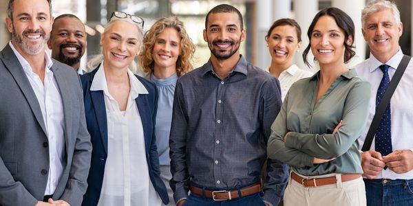 Portrait of happy businessmen and satisfied businesswomen standing as a team. Multiethnic group.