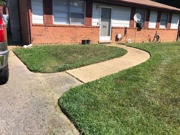 The result of the 'before' pic after mowing, edging, and trimming.