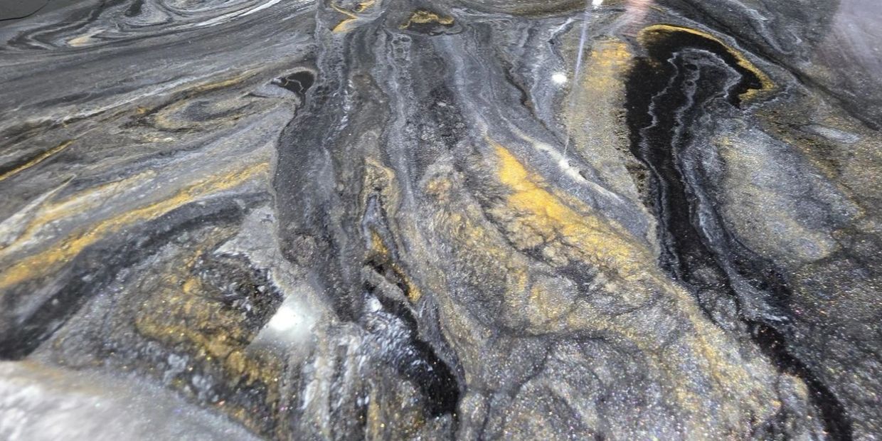 Close-up of a black and gold marbled surface.