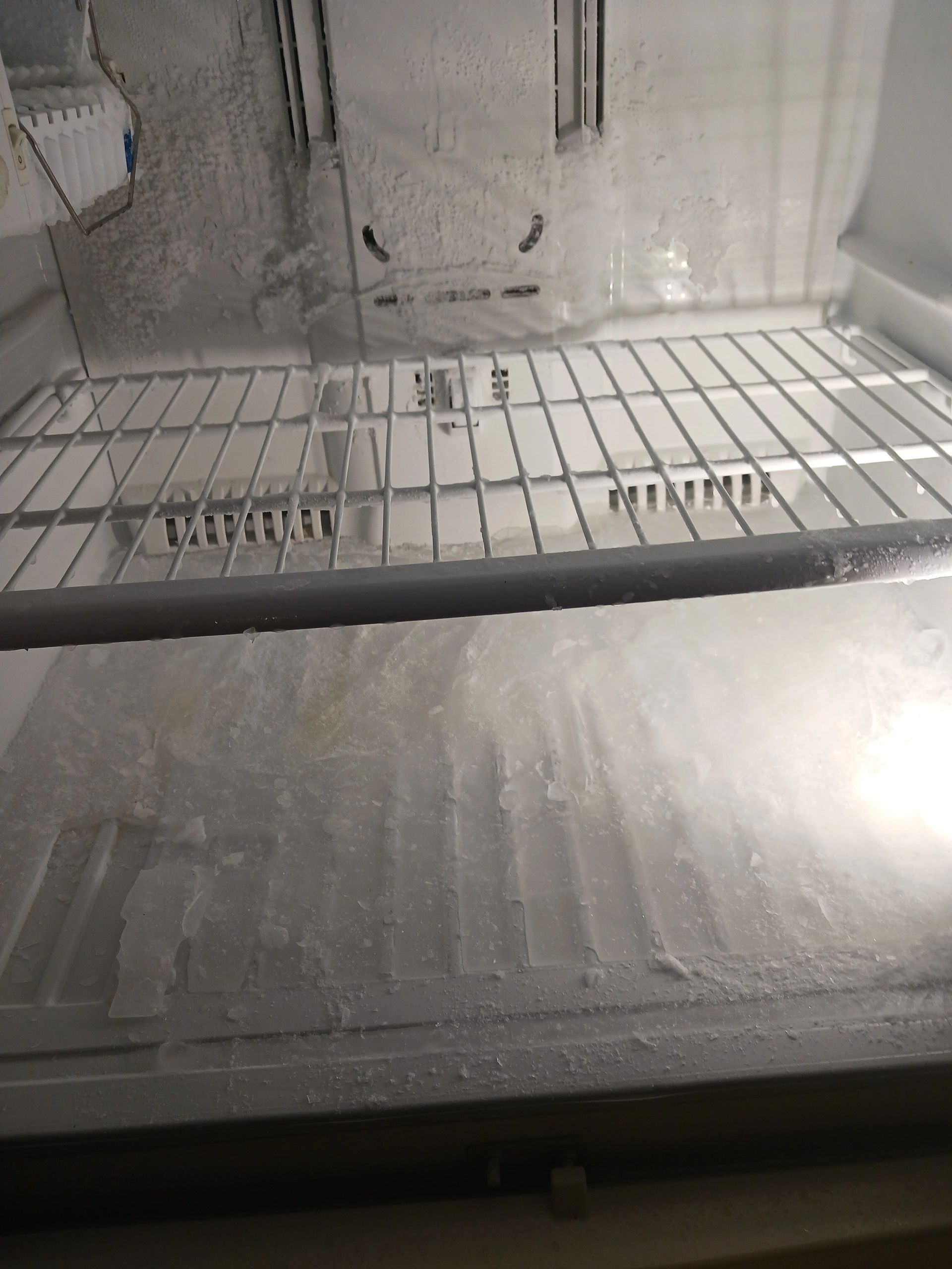Frosted Freezer and built-up ice on floor from fan not running