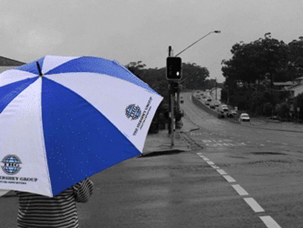 Person holding custom branded umbrella