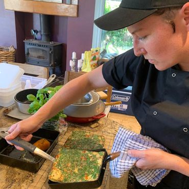 Private chef in domestic kitchen removes Spanish omlette from square pan
