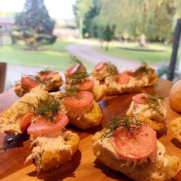 Smoked mackerel pate on toast with radish and dill. Canapes on wooden board
