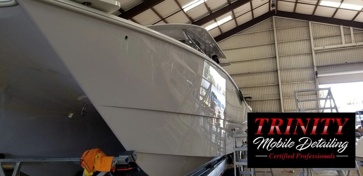 Polished boat hull inside a large shed.