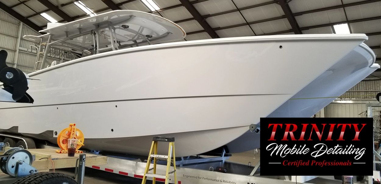 White boat on trailer inside a warehouse.