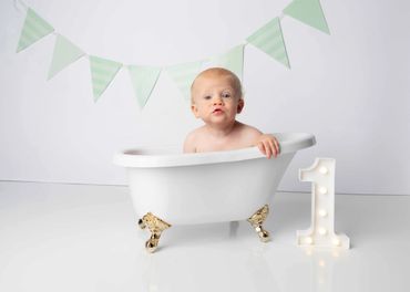 Baby in bathtub on a cake smash photography studio set 