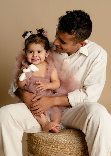 Brother holds sister during a family photo session in an Austin, Texas photography studio. 