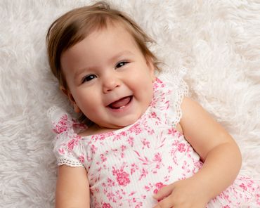 Baby smiles during her milestone photoshoot in Austin, Texas photography studio.
