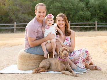 Family pose with their dog for an outdoor family photography mini session in Austin, Texas. 