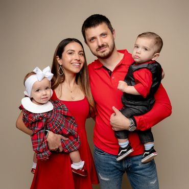 Mom and dad hold their twins during a family photography session in Austin, Texas photography studio