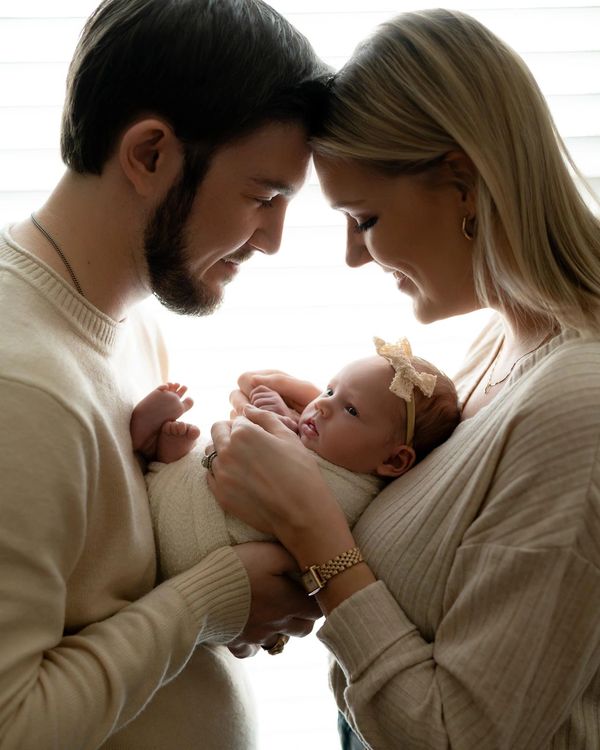 Couple hold baby during their newborn photography session in Austin.